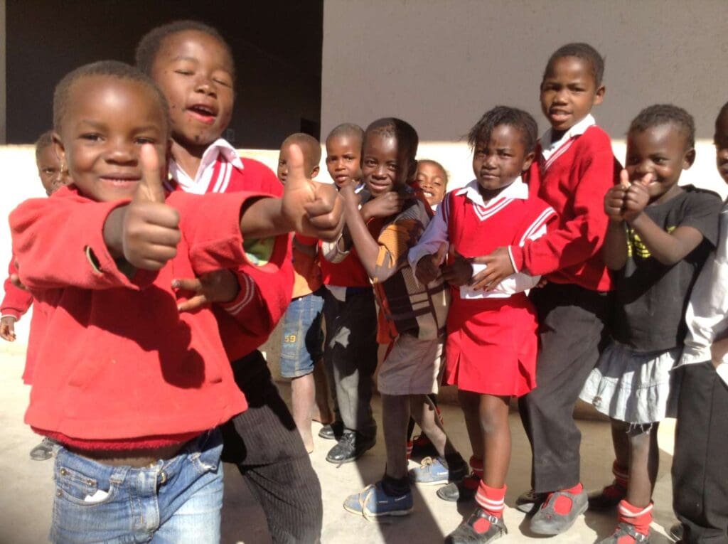 Children showing a thumbs up for the camera