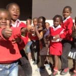 Children showing a thumbs up for the camera