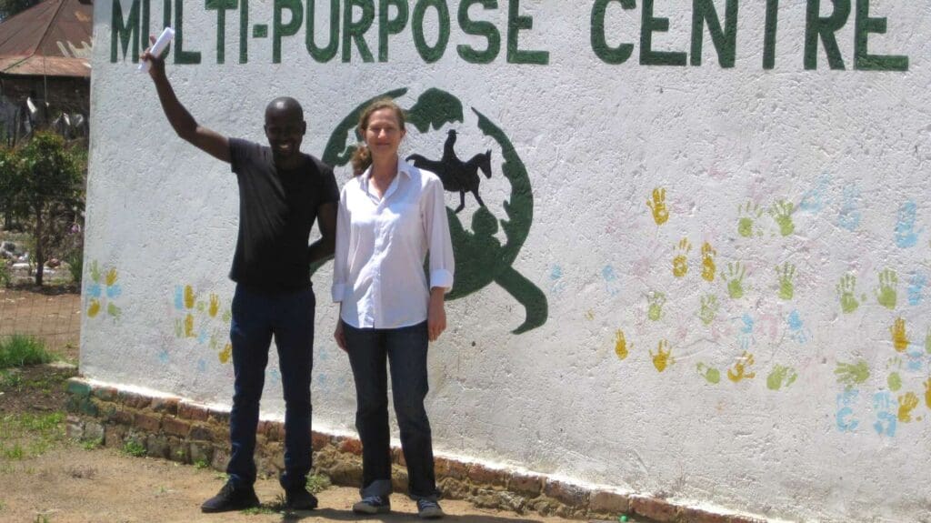 Rafael & Stella posing in front of the multi-purpose centre wall