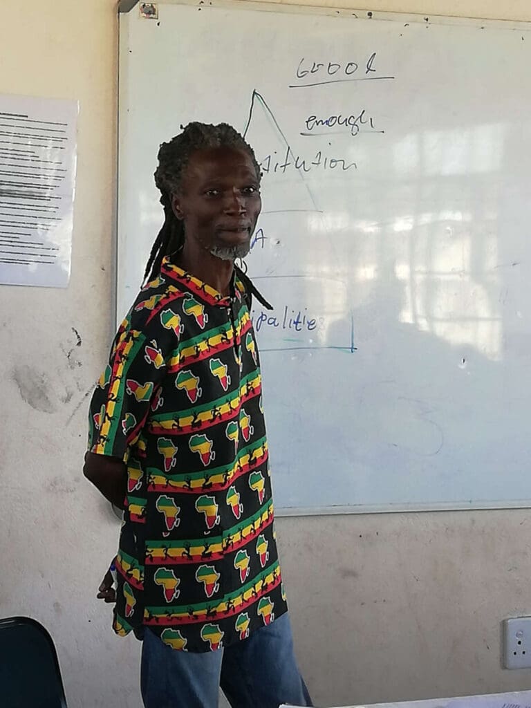 December standing next to a white board