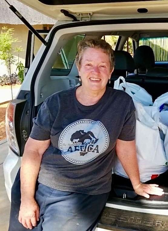 Becky Harmon posing from the boot of a car.