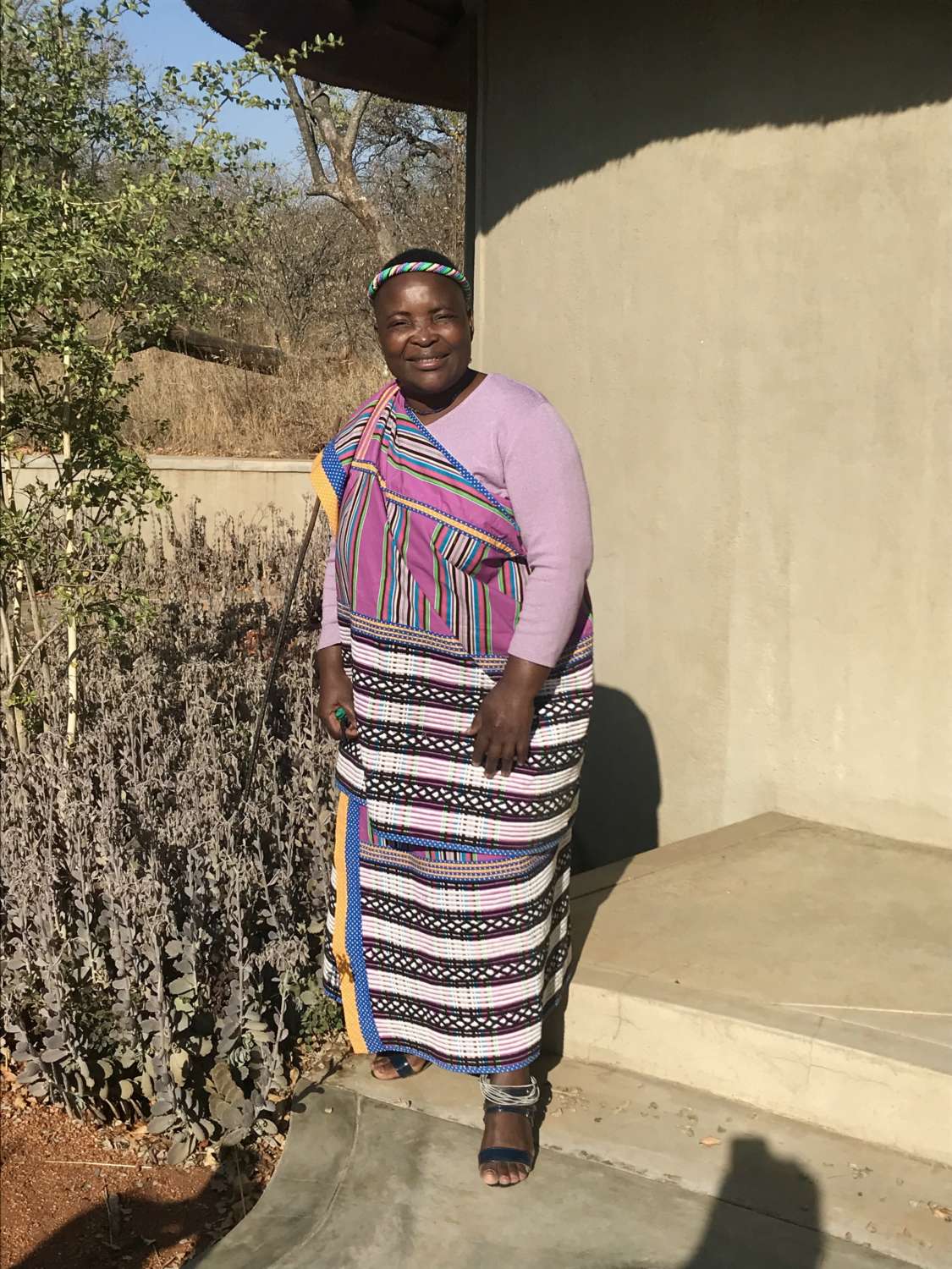 Lillian posing in her traditional clothes on the steps