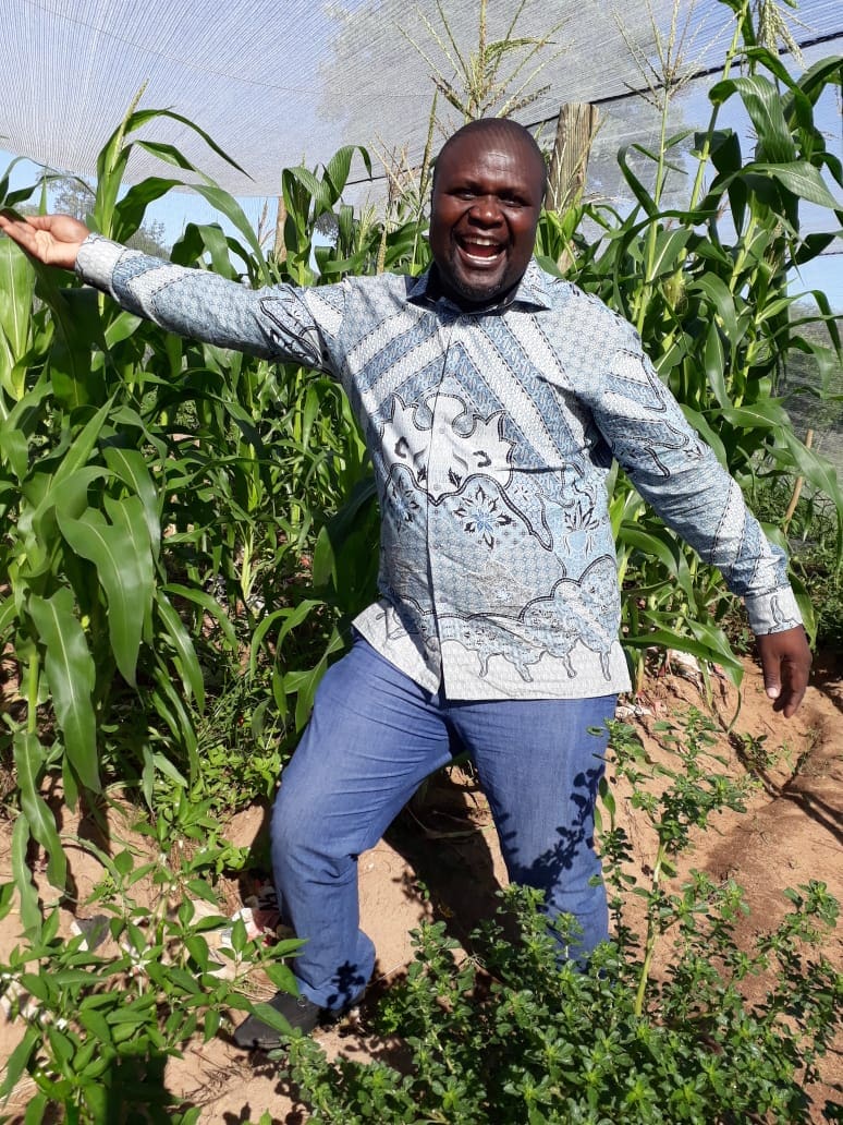 Trygive posing in front of some corn crops