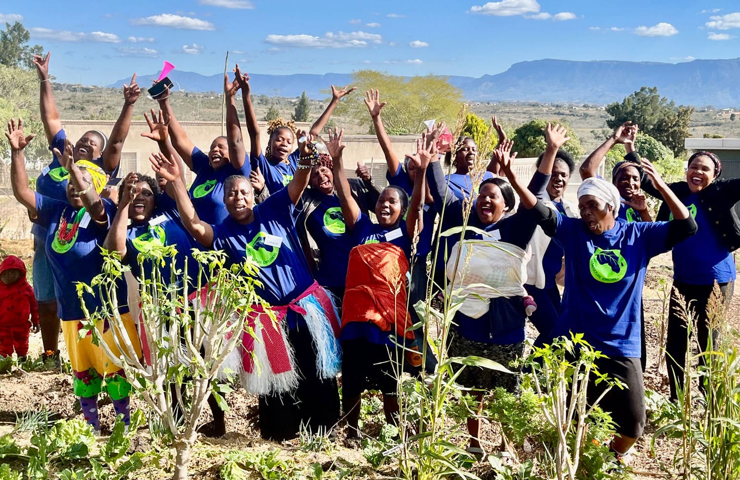 PE Joy group celebrating in the veggie garden